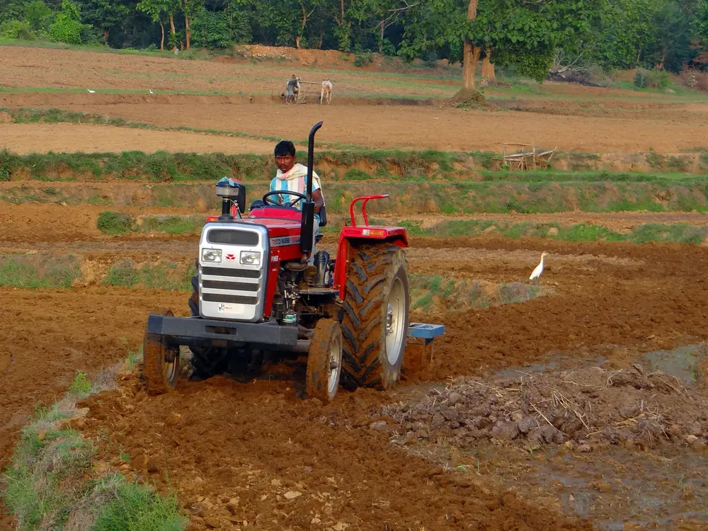 A farmer ploughing a field with a tractor